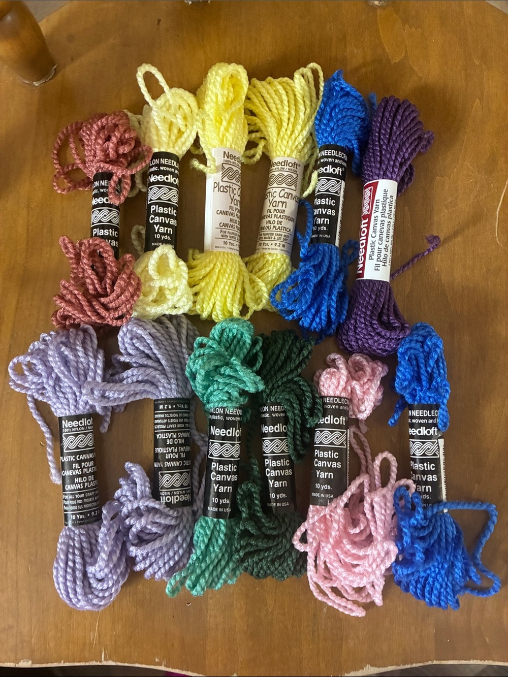12 multi colored plastic canvas yarns 10 yards each
